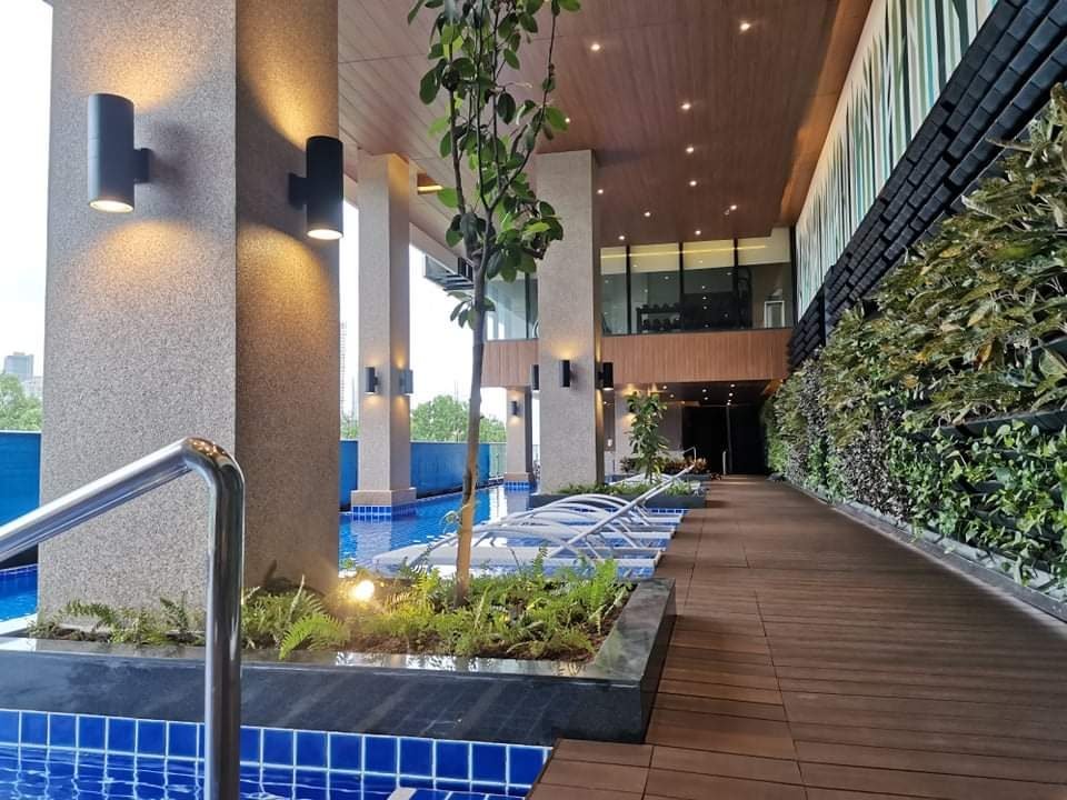 Finished amenity pool deck with uplit columns and living wall